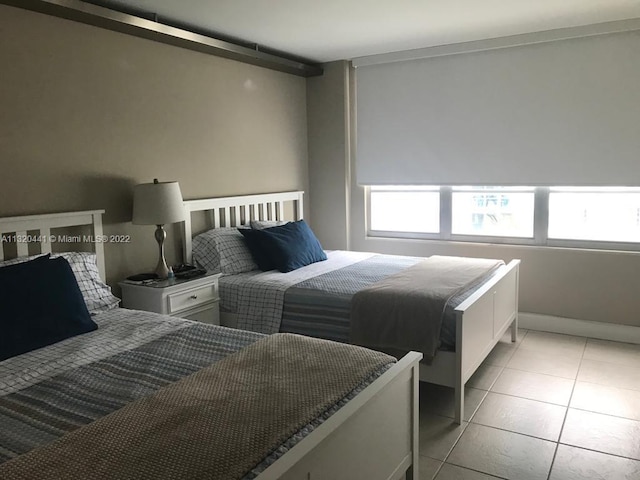 bedroom with light tile floors