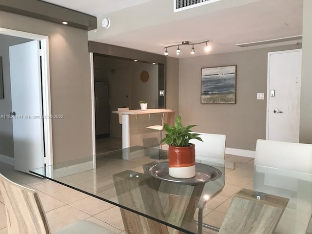 tiled dining space with track lighting