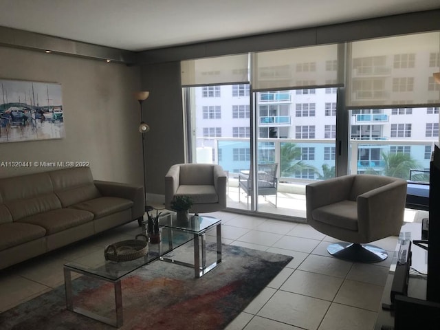 living room featuring a healthy amount of sunlight and light tile floors