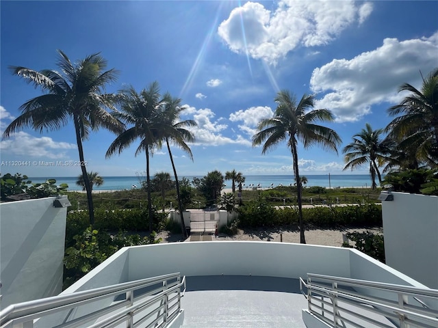 view of patio / terrace with a balcony and a water view