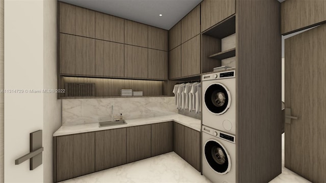 clothes washing area with stacked washer / dryer