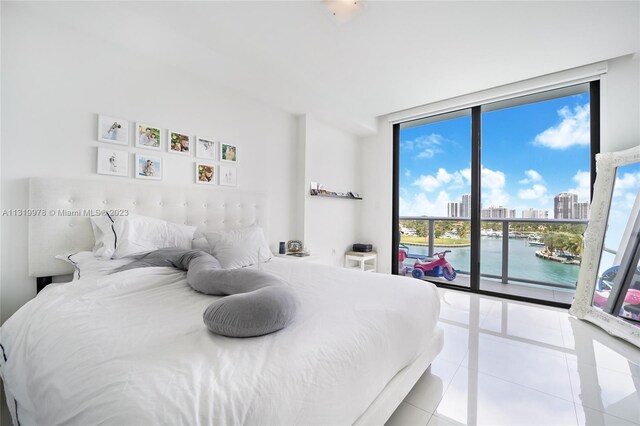 tiled bedroom with floor to ceiling windows and a water view