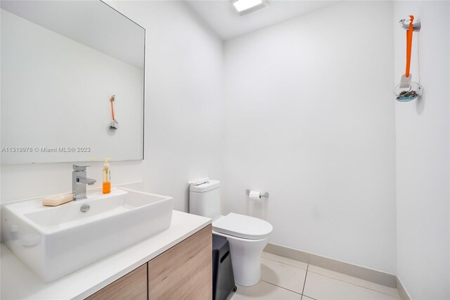 bathroom with vanity, toilet, and tile flooring