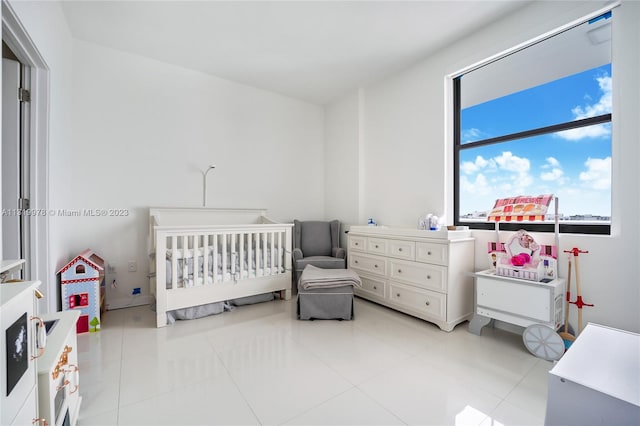 tiled bedroom featuring a crib