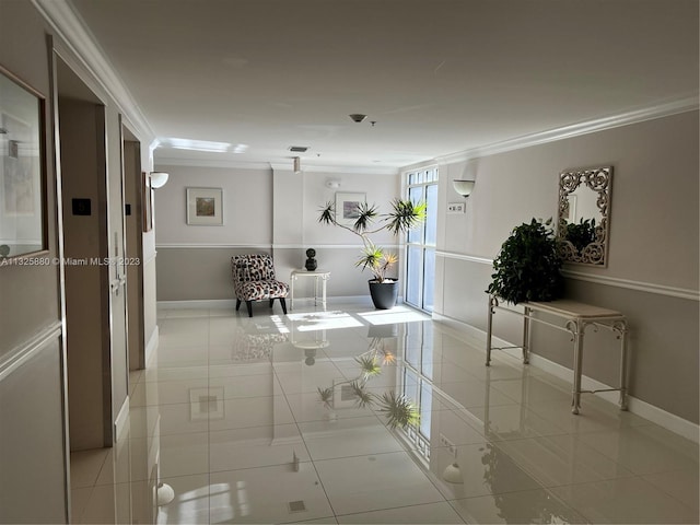 corridor with light tile floors and crown molding