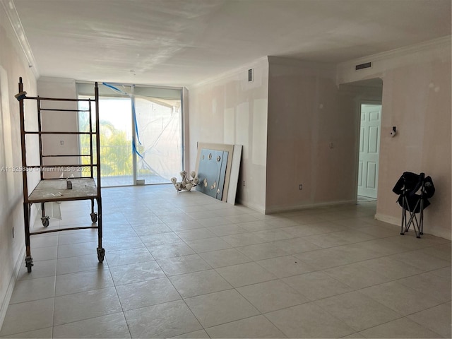 unfurnished living room with light tile floors, crown molding, and a wall of windows