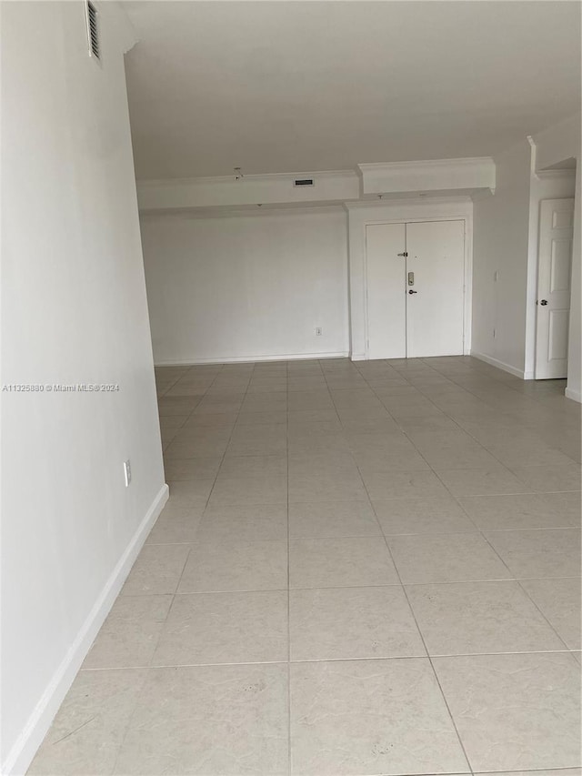 unfurnished room featuring light tile floors