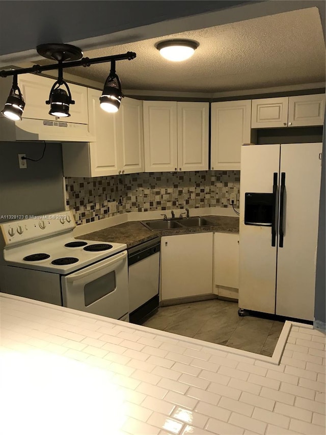 kitchen with white cabinetry, sink, hanging light fixtures, a textured ceiling, and white appliances