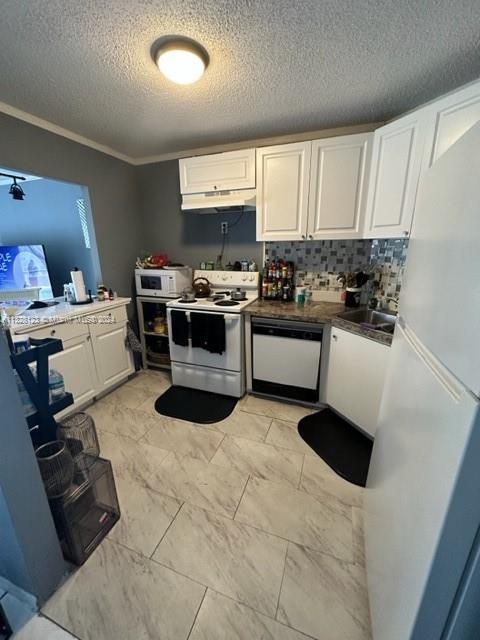 kitchen with a textured ceiling, white appliances, crown molding, sink, and white cabinets