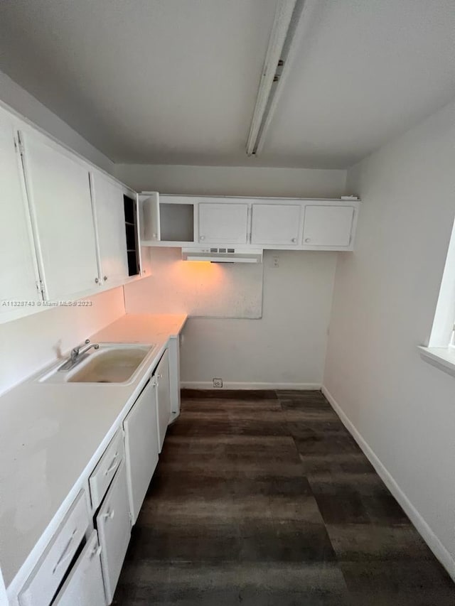 kitchen with dark hardwood / wood-style floors, white cabinetry, and sink