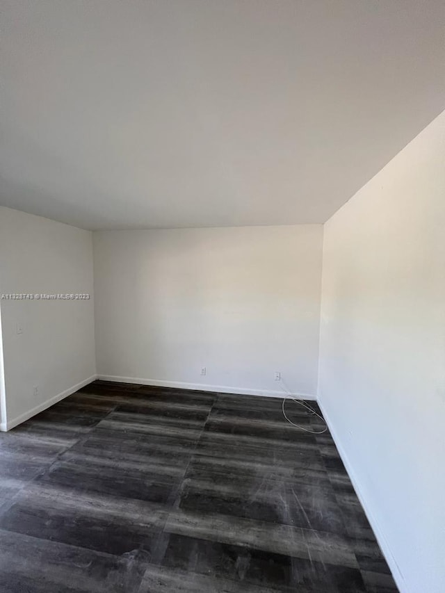 spare room featuring dark hardwood / wood-style floors