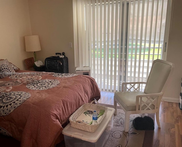 bedroom with access to outside and light hardwood / wood-style flooring