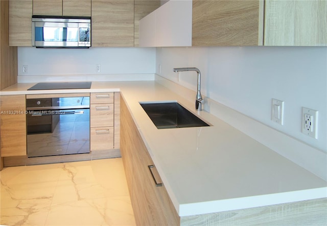 16385 Biscayne Blvd Unit 2016, North Miami Beach, FL 33160 - kitchen with light tile floors, light brown cabinets, black appliances, and sink