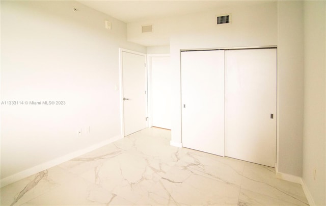 16385 Biscayne Blvd Unit 2016, North Miami Beach, FL 33160 - unfurnished bedroom with a closet and light tile floors