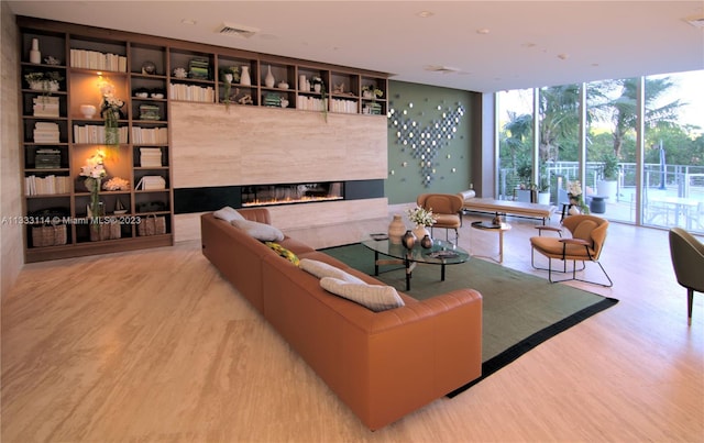16385 Biscayne Blvd Unit 2016, North Miami Beach, FL 33160 - living room with built in features, expansive windows, light hardwood / wood-style floors, and a fireplace