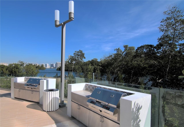 16385 Biscayne Blvd Unit 2016, North Miami Beach, FL 33160 - exterior space featuring exterior kitchen, a water view, and a grill