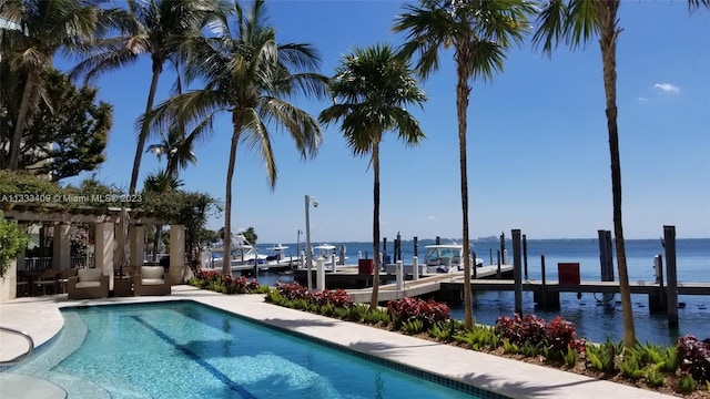 view of pool featuring a dock and a water view