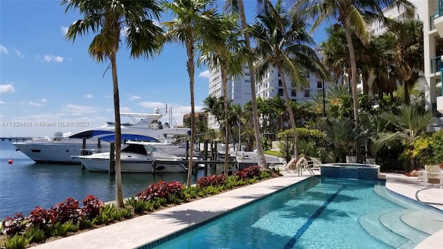 view of pool featuring a water view