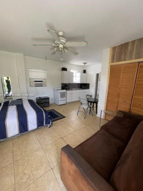 tiled living room with ceiling fan