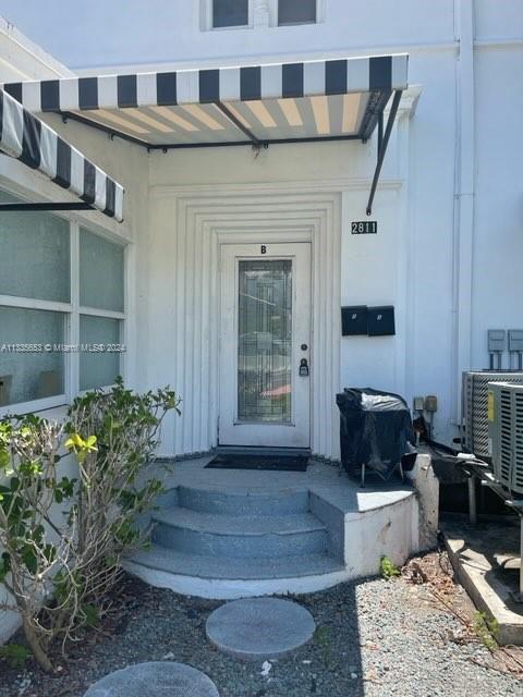 doorway to property featuring cooling unit