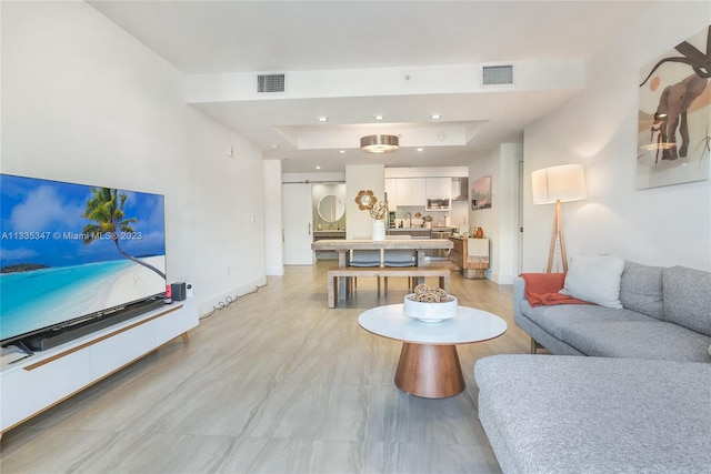 tiled living room with a raised ceiling