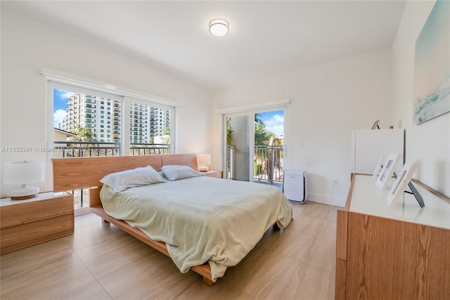 tiled bedroom featuring access to outside and multiple windows