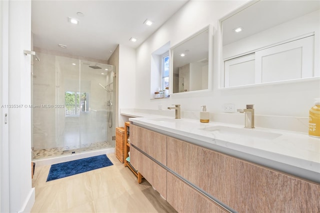 bathroom with an enclosed shower and double vanity