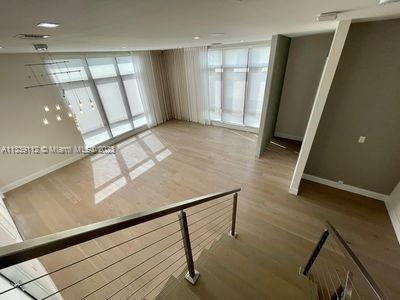 interior space with floor to ceiling windows and hardwood / wood-style flooring