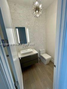 bathroom featuring hardwood / wood-style floors and oversized vanity