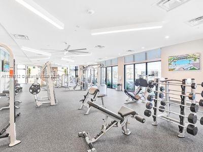 exercise room with ceiling fan