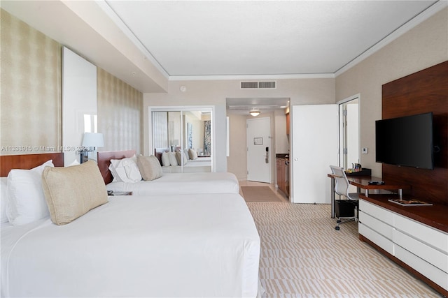 bedroom featuring crown molding and light colored carpet