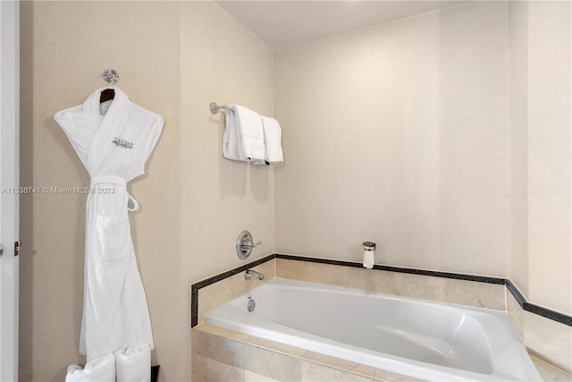 bathroom featuring tiled tub