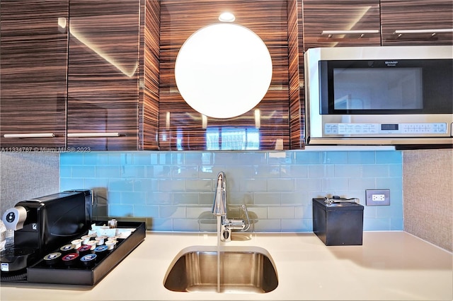 kitchen featuring backsplash and sink