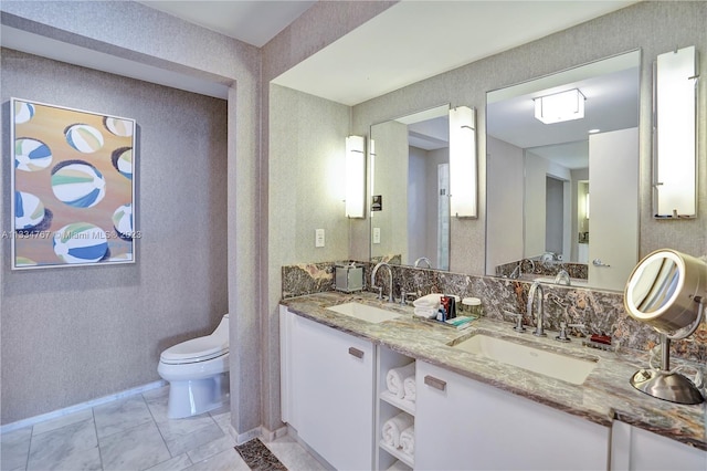 bathroom featuring dual vanity, tile floors, and toilet