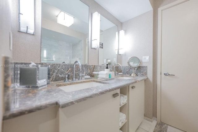 bathroom with double sink, large vanity, and tile flooring