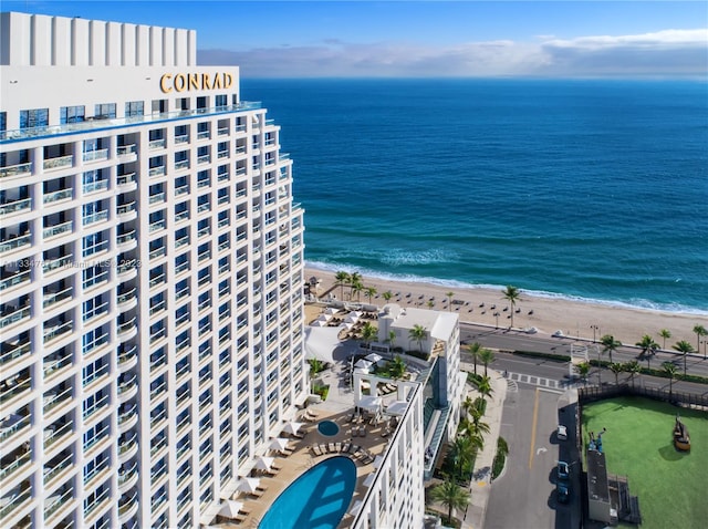 drone / aerial view featuring a water view and a view of the beach