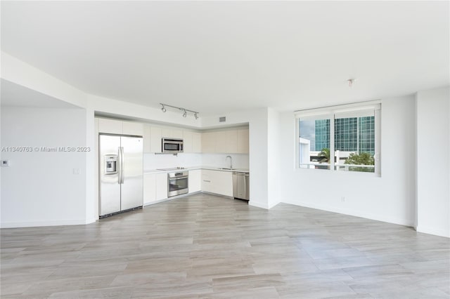 kitchen featuring appliances with stainless steel finishes, track lighting, and sink