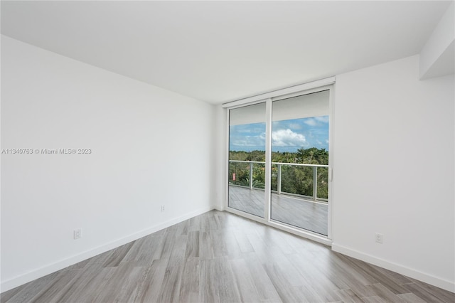 unfurnished room with light wood-type flooring