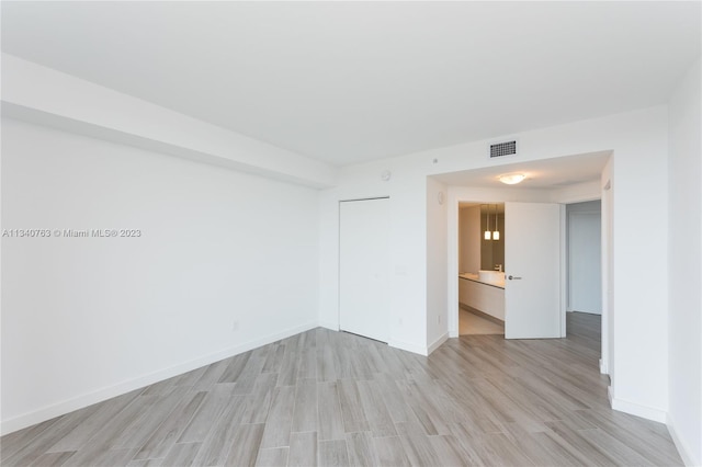 spare room with light wood-type flooring