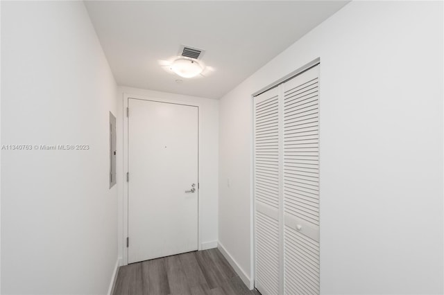 corridor with dark hardwood / wood-style flooring