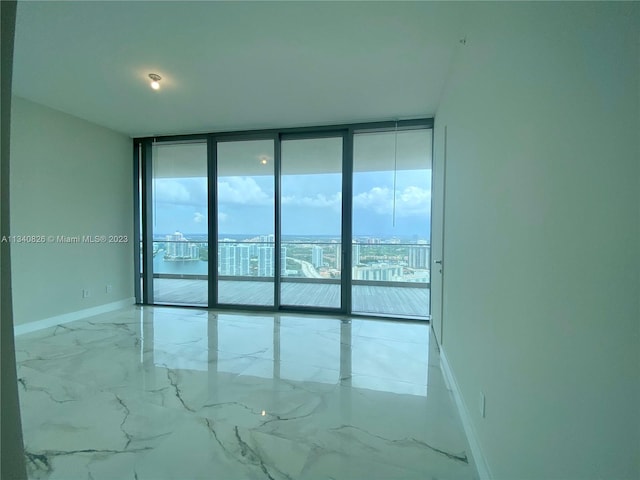 unfurnished room with floor to ceiling windows