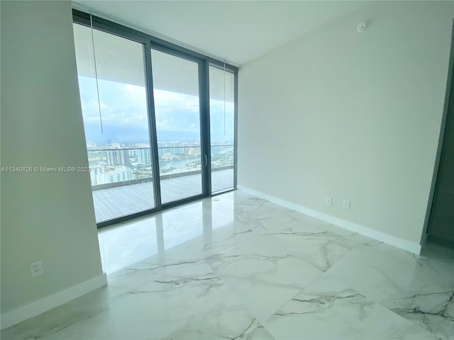 unfurnished room featuring expansive windows