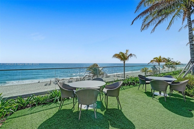 balcony featuring a water view and a beach view