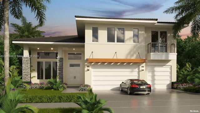 view of front of property featuring a balcony and a garage