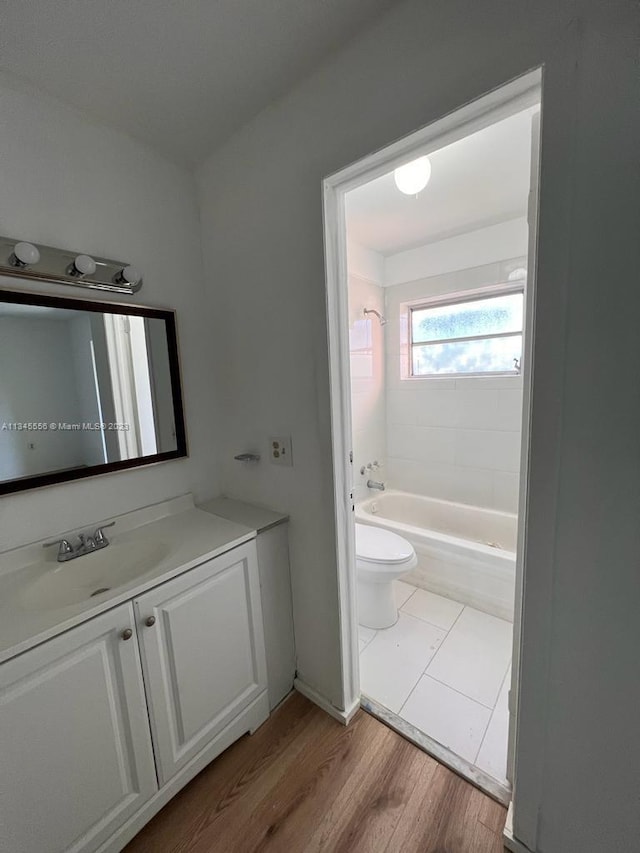 full bathroom with shower / bath combination, vanity, tile floors, and toilet