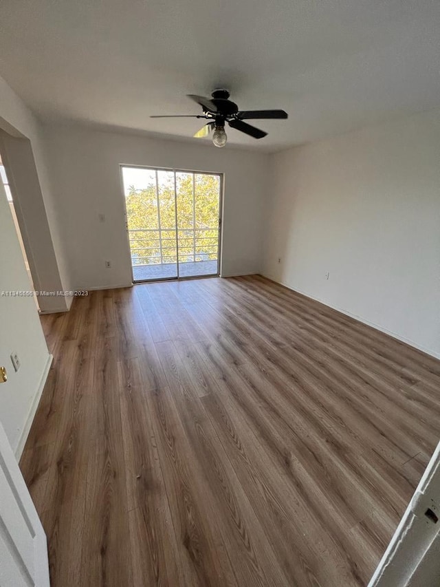 spare room featuring ceiling fan and hardwood / wood-style flooring