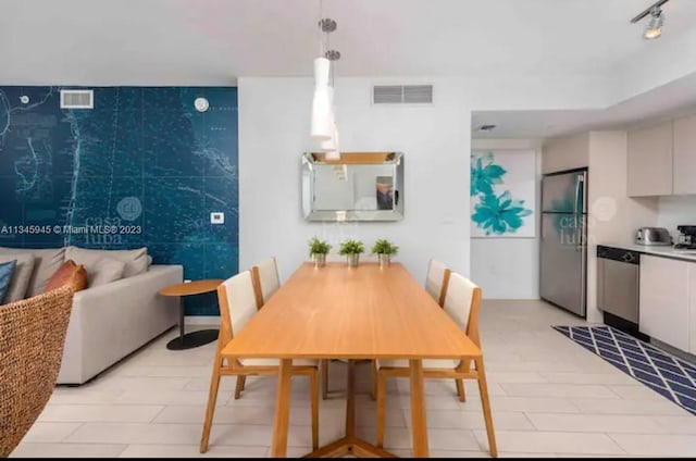 dining room featuring rail lighting