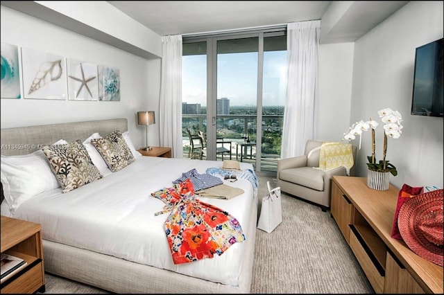 bedroom featuring access to outside and floor to ceiling windows