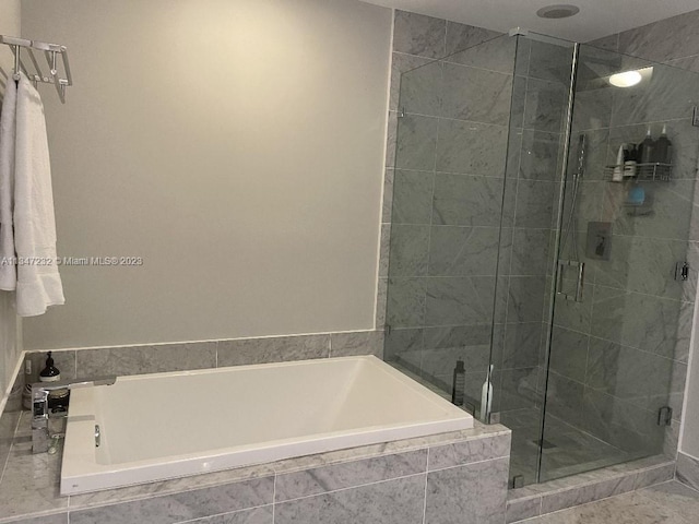 bathroom with tile floors and separate shower and tub