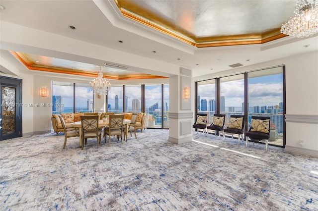 interior space with a raised ceiling, crown molding, carpet floors, and a notable chandelier